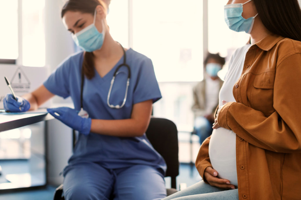 Pregnant Lady In Mask On Appointment At Doctor’s Office